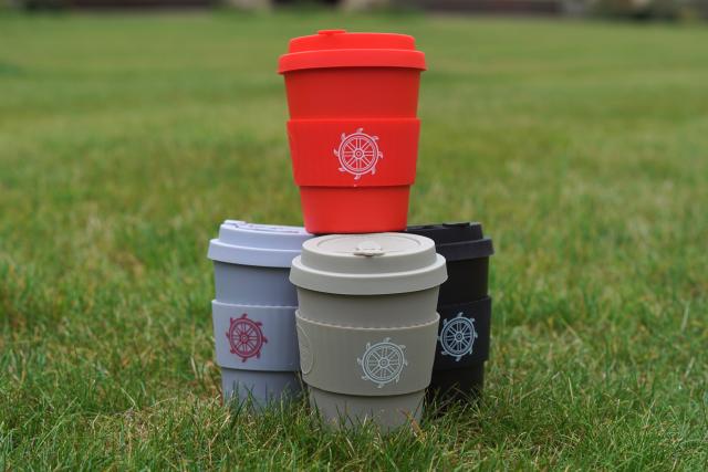 St Catharine's-branded KeepCups in a stack on a lawn